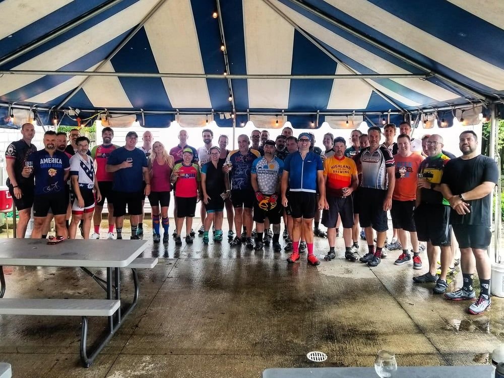 Mountain bikers from the RBRTC community gathered together under a tent